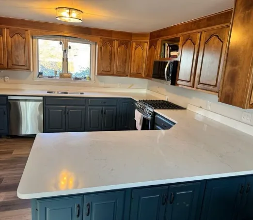 Quartz countertop with teal cabinets